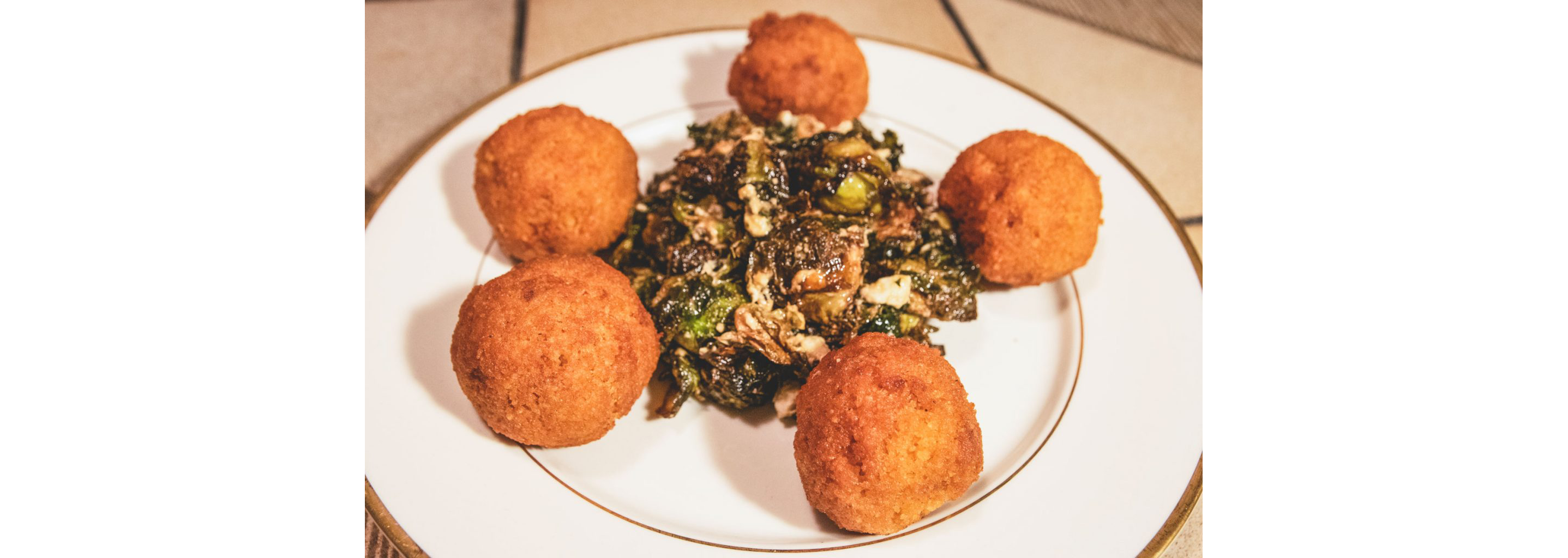 Falafels served delicately on a white plate.