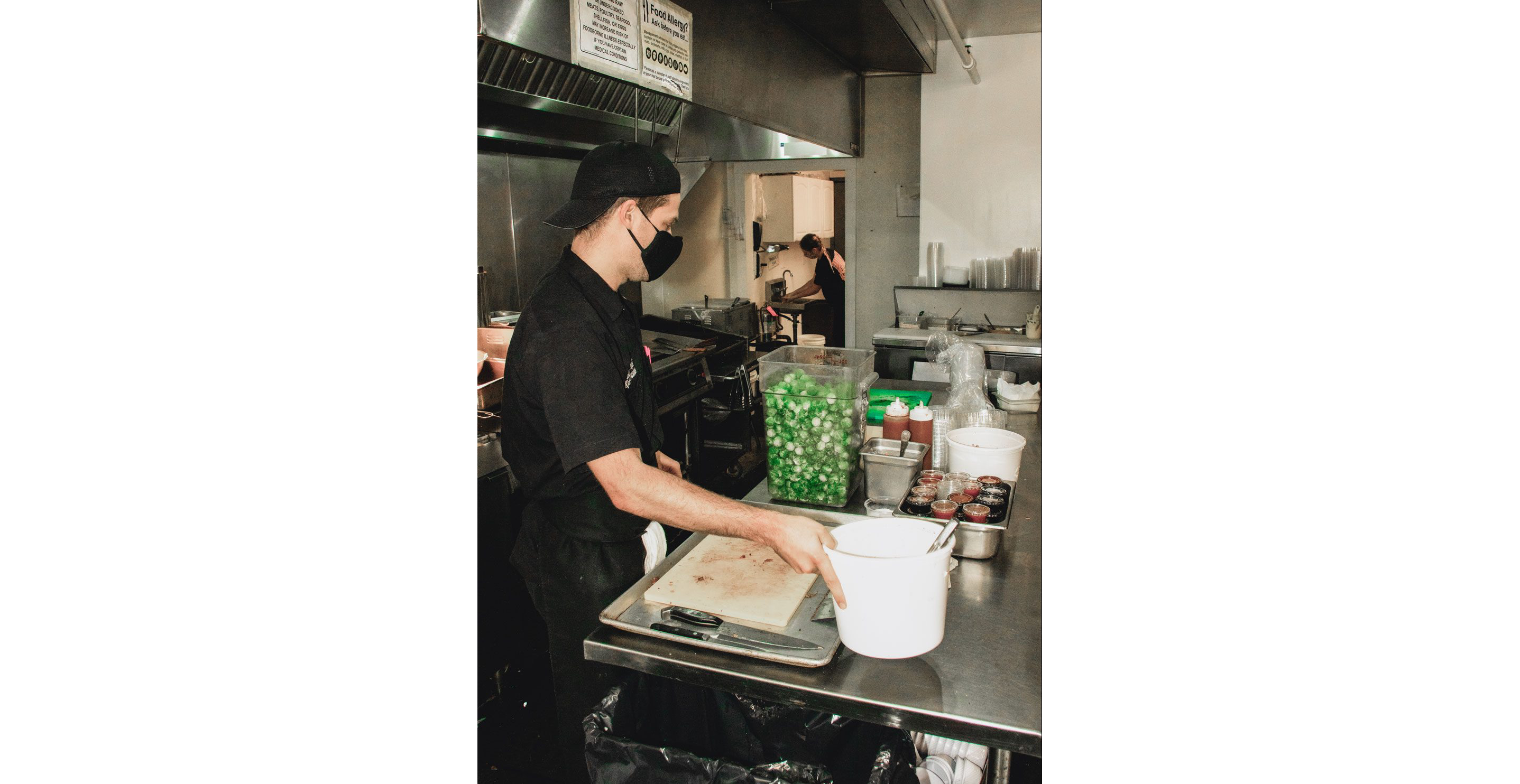 A man working diligently in the restaurant's kitchen.