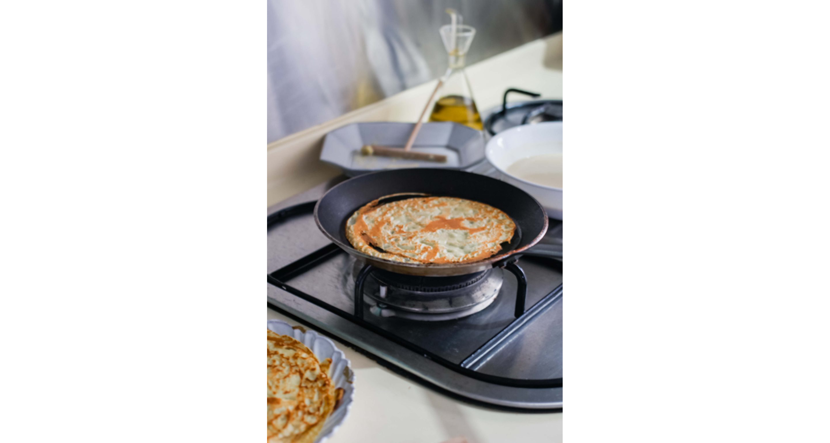 A small pan cooking a crepe.