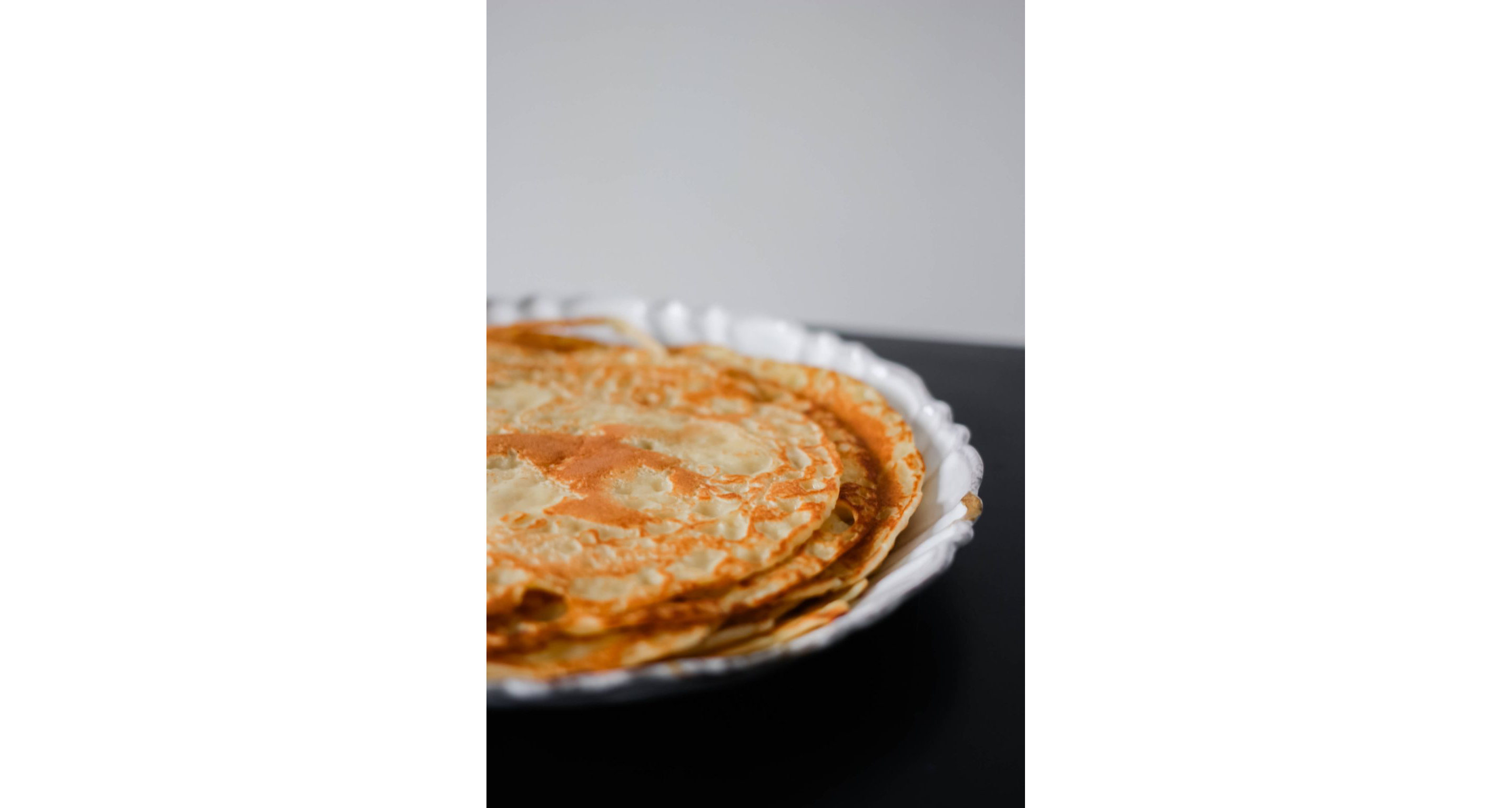 A plate filled with freshly made crepes.