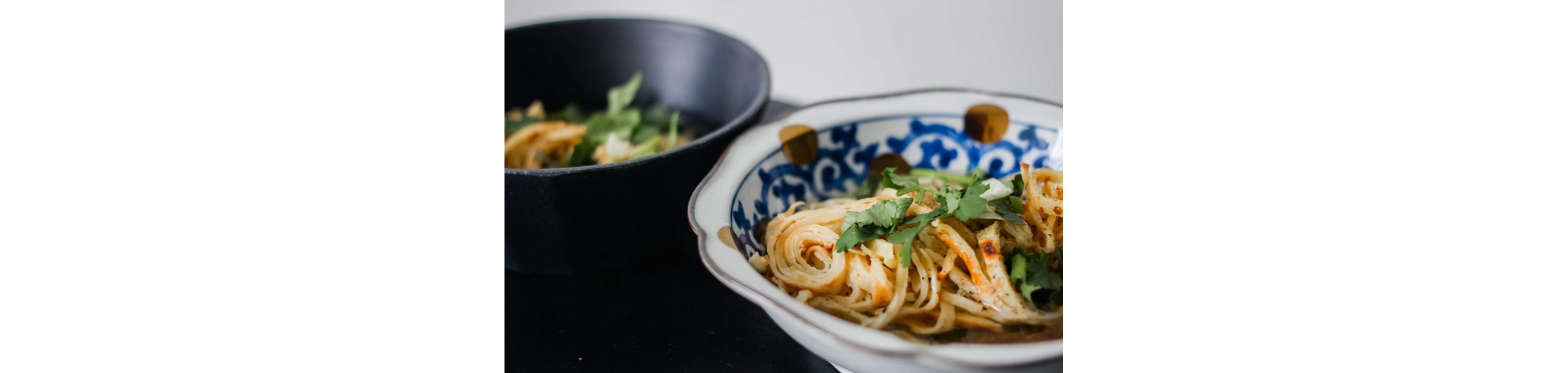 A bowl of crepe noodles in broth.