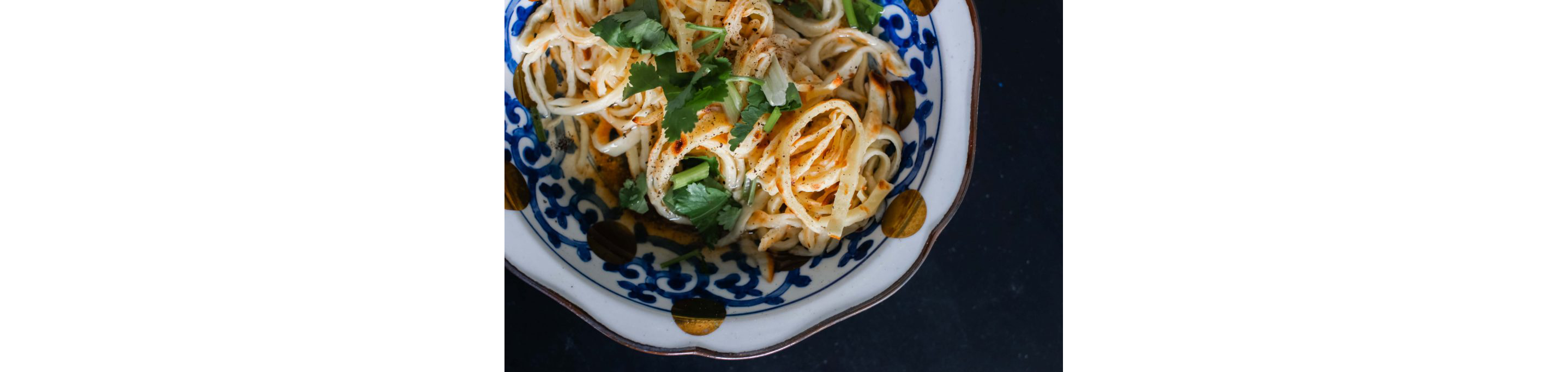 A bowl of crepe noodles in broth.