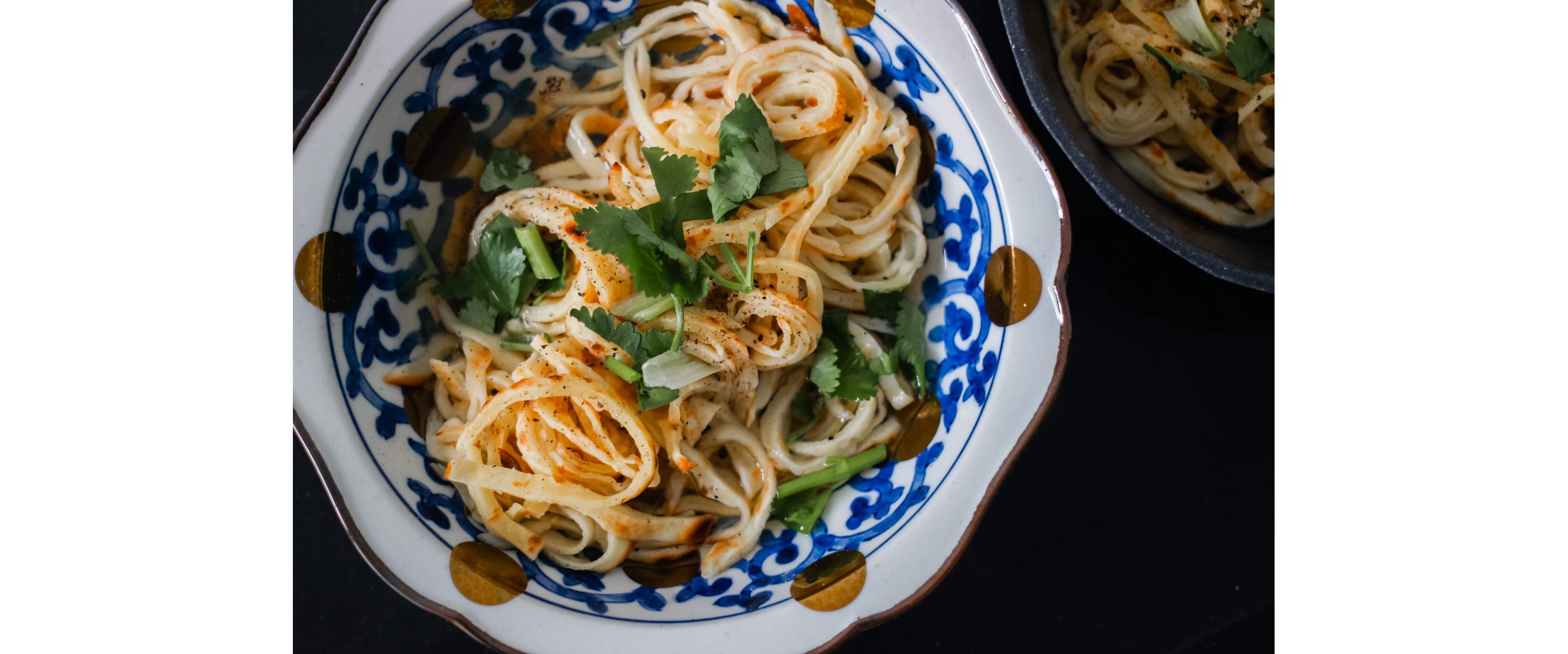 A bowl of crepe noodles in broth.