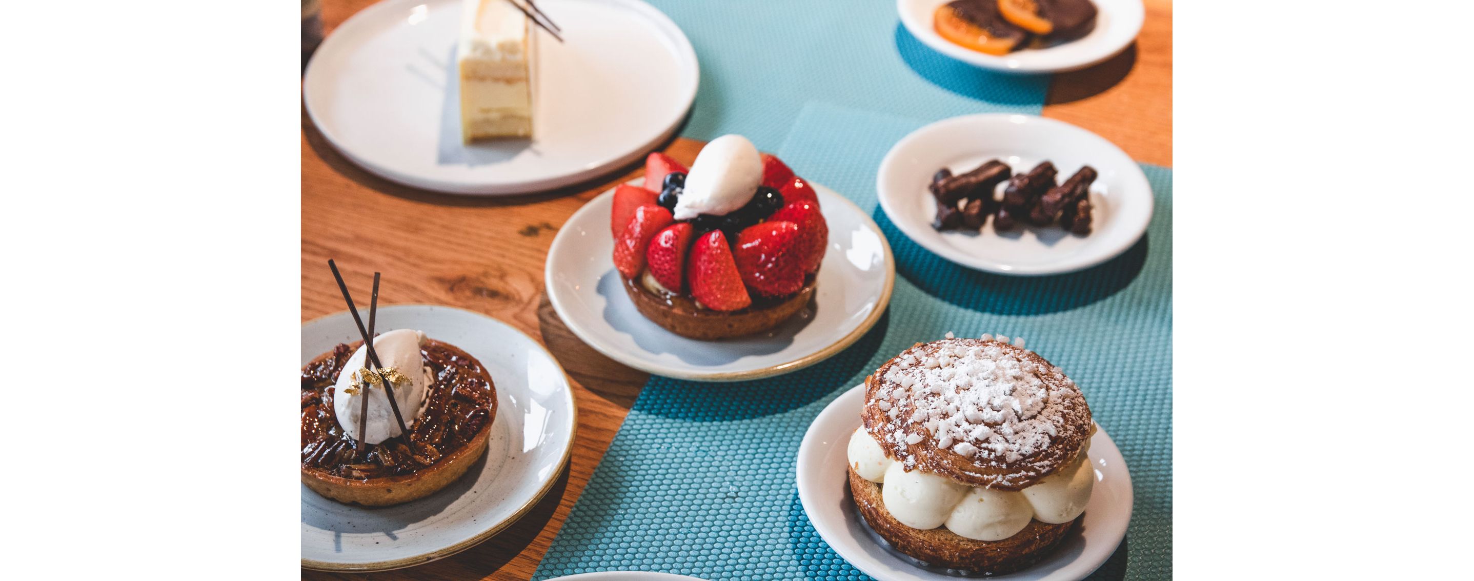 Small, decadent pastries resting on white plates.