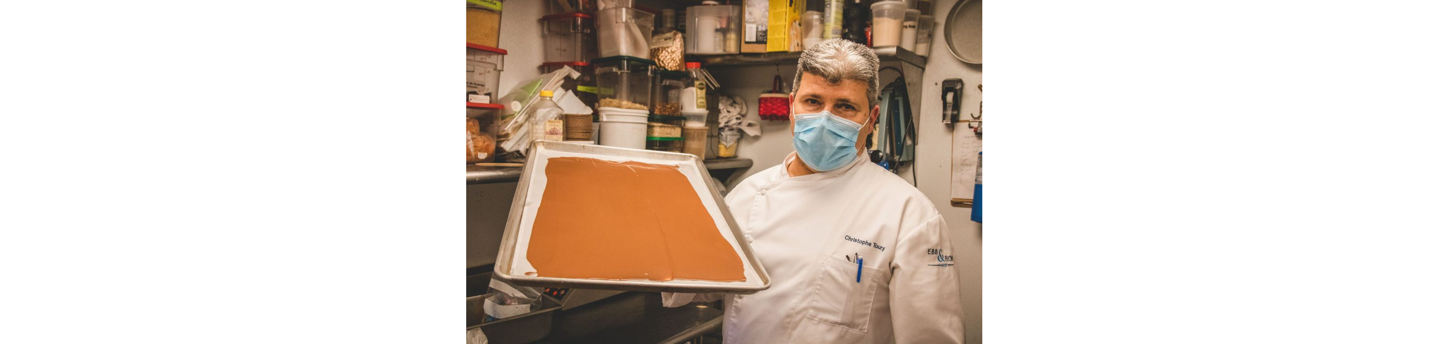 Chef Christophe Toury holding a sheet of chocolate.
