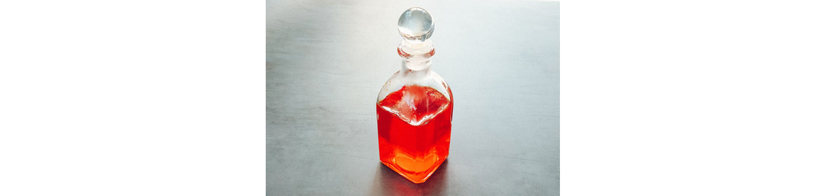 A small glass bottle holding Gold Water.