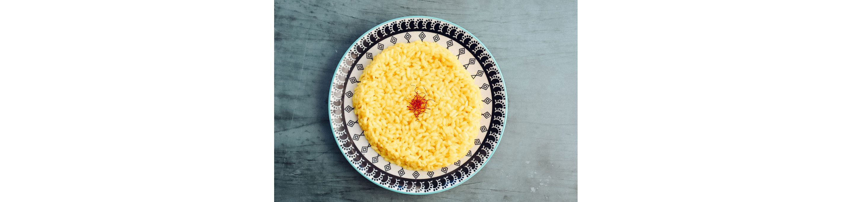 A elaborate dish holding a perfect circle of basmati rice topped with saffron.