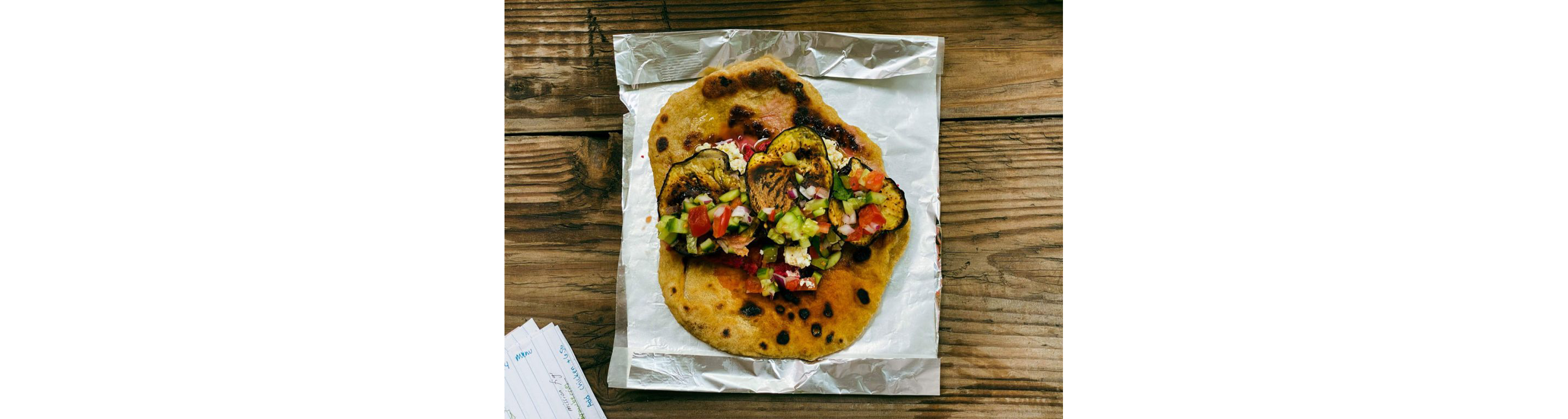 Pita bread topped with sauteed vegetables.