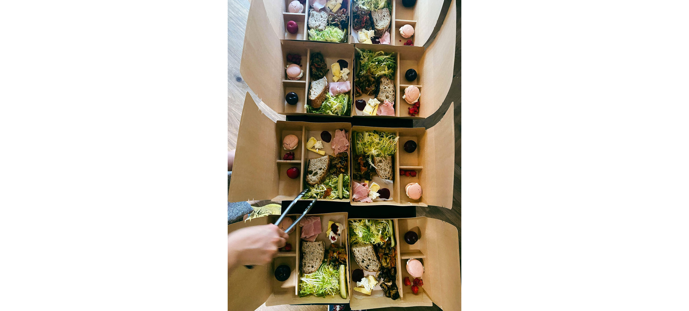A person putting together picnic boxes.