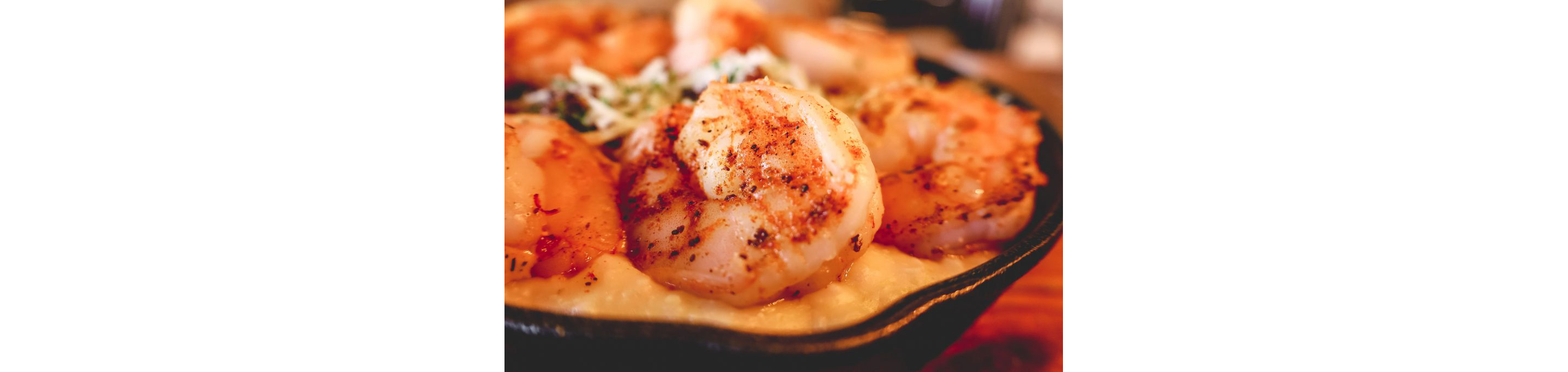 A closeup of a perfectly seasoned shrimp.
