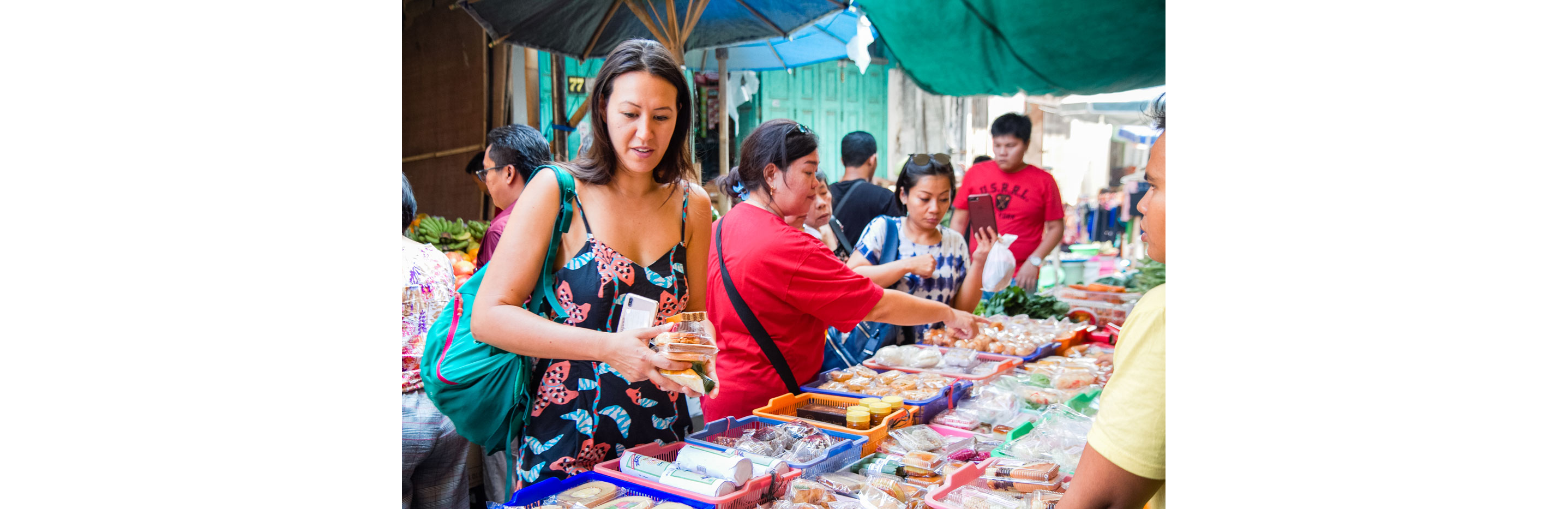 Women shopping at an outdoor market.
