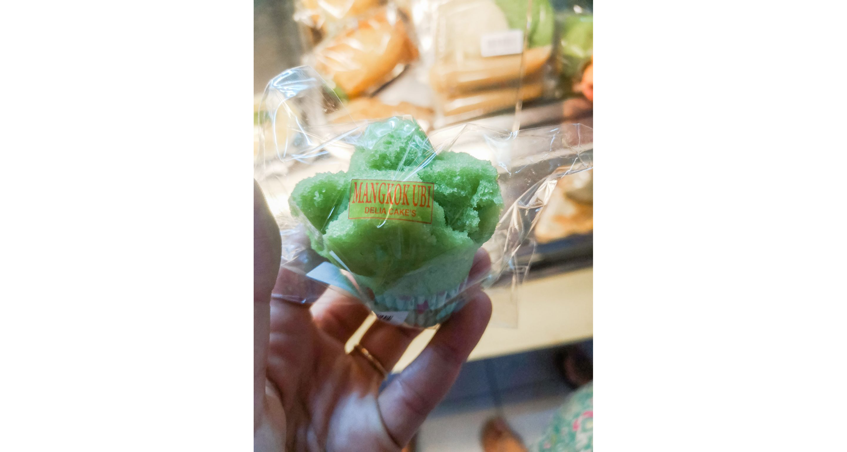 A green kue mangkok, a cupcake-like Indonesia dessert.