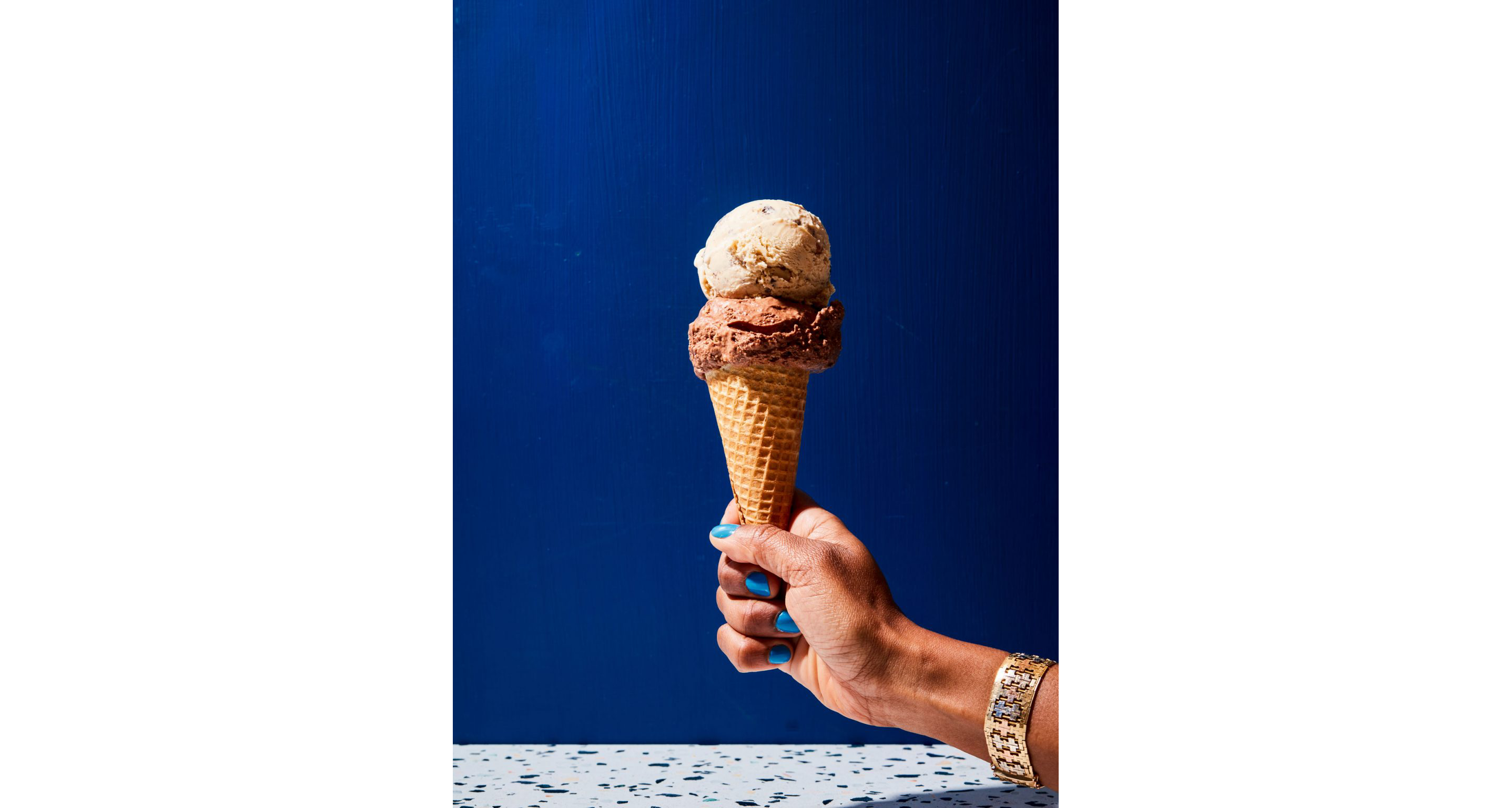 A person holding an ice cream cone.