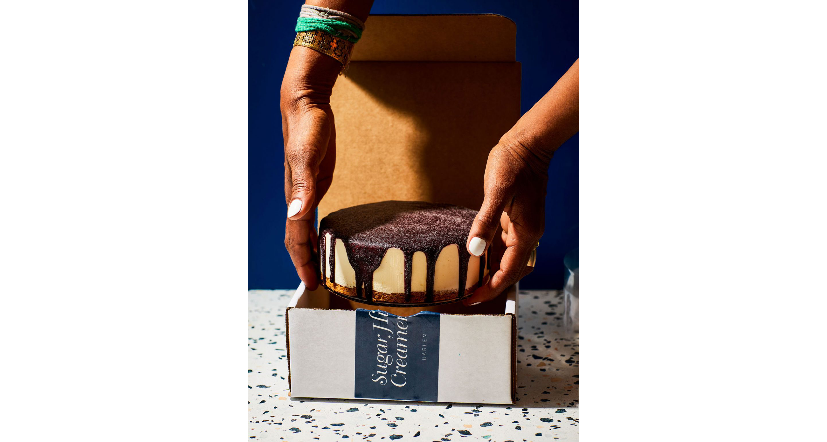 A person placing ice cream cake into a box.