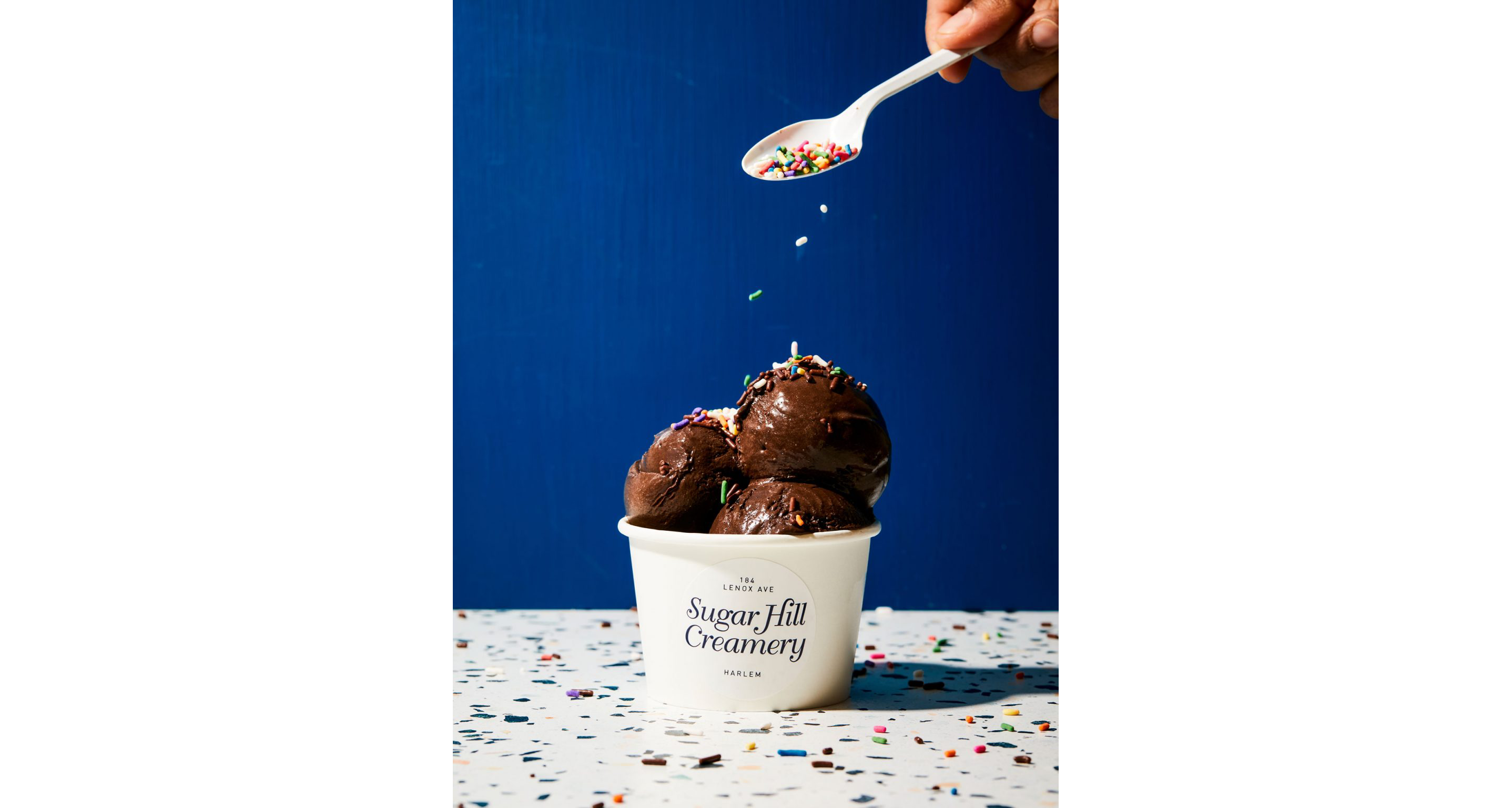 Sprinkles being sprinkled on top of ice cream.