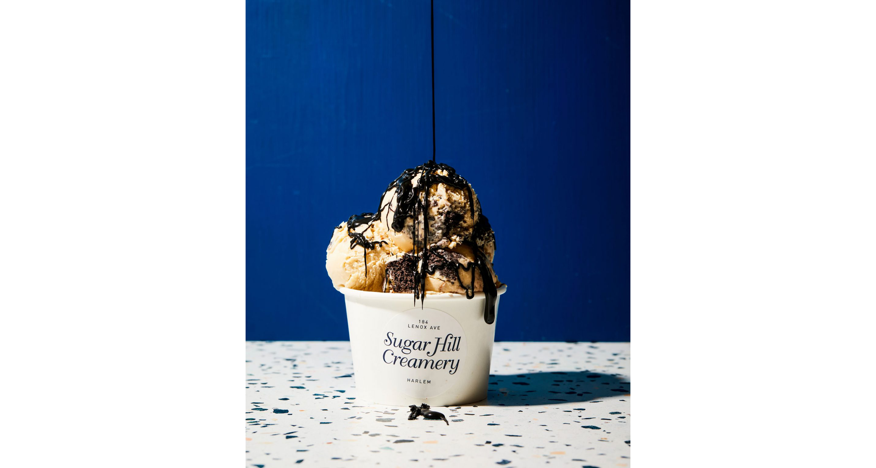 Chocolate syrup poured on top of ice cream.