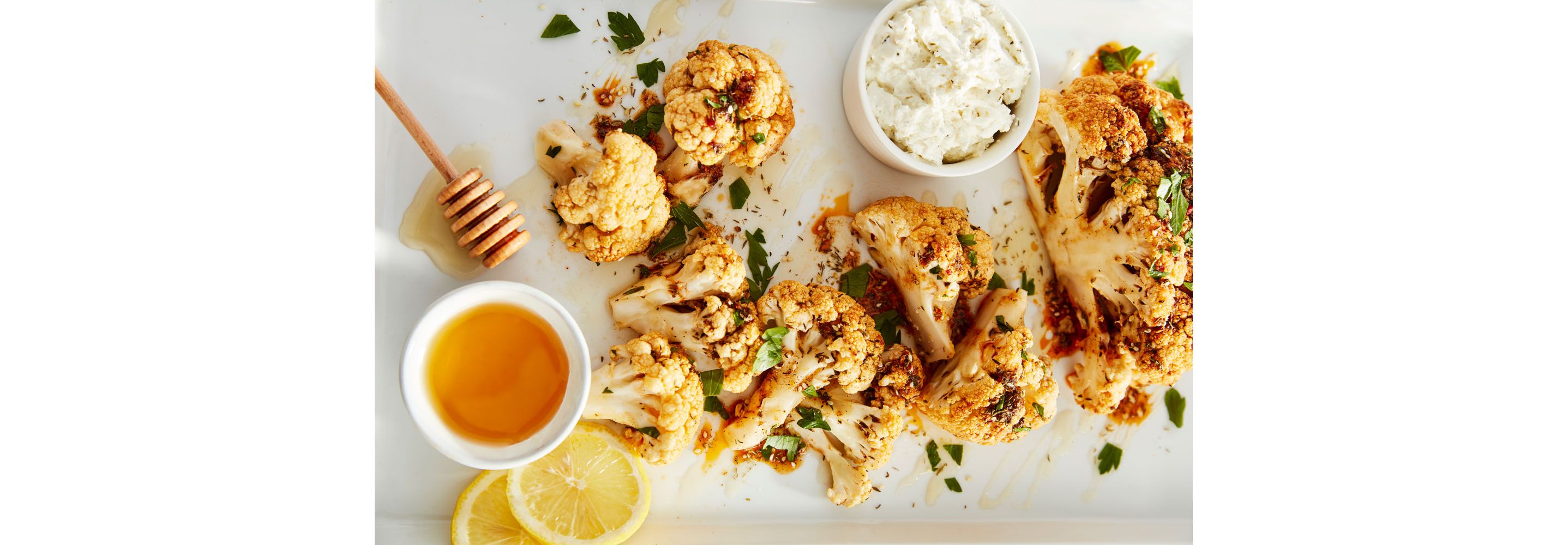 A tray of roasted cauliflower drizzled in honey.