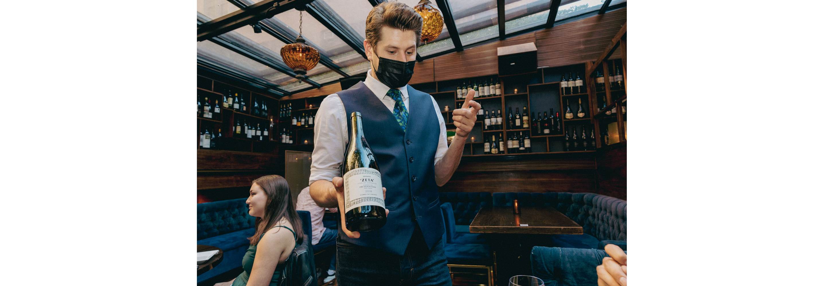 A server presenting a bottle.