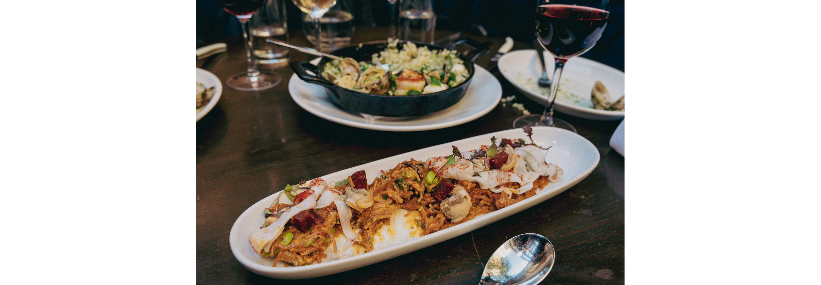 Two dishes served on a dining room table.