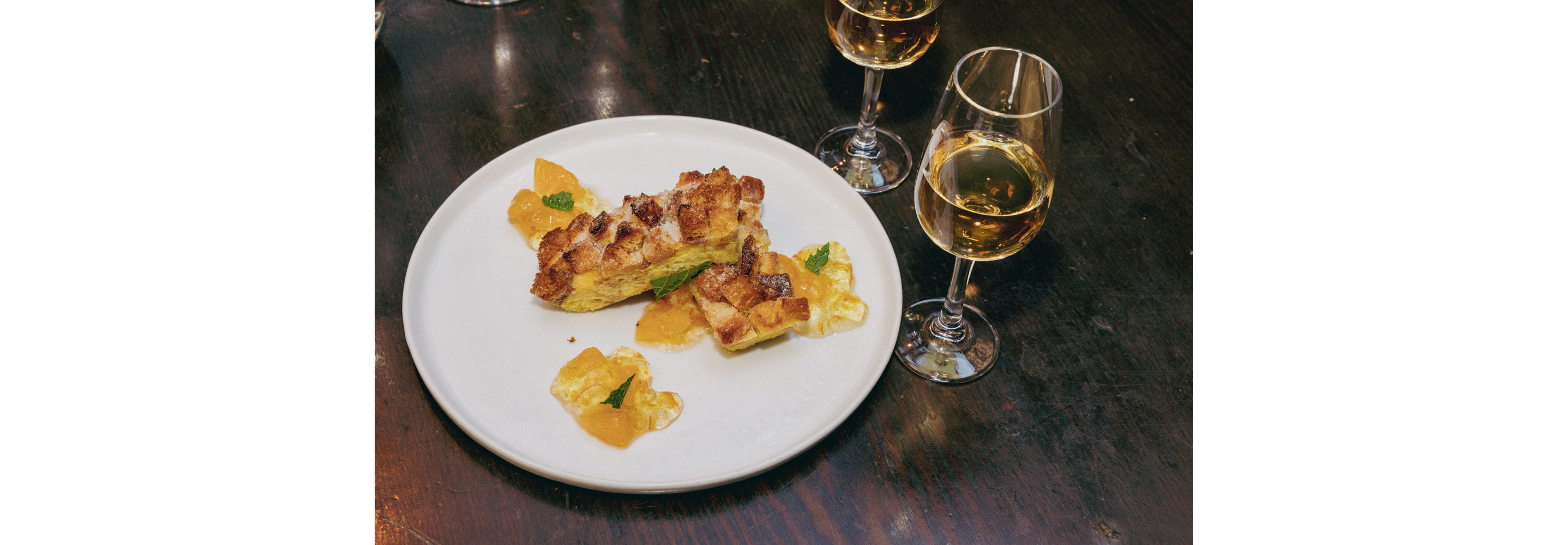 A dish served with two glasses of wine.