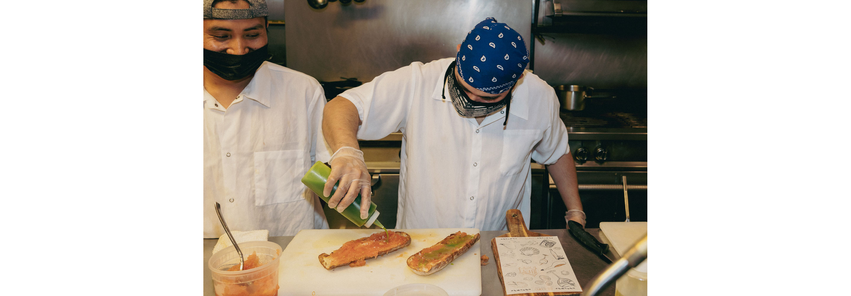 A chef dressing a meal.