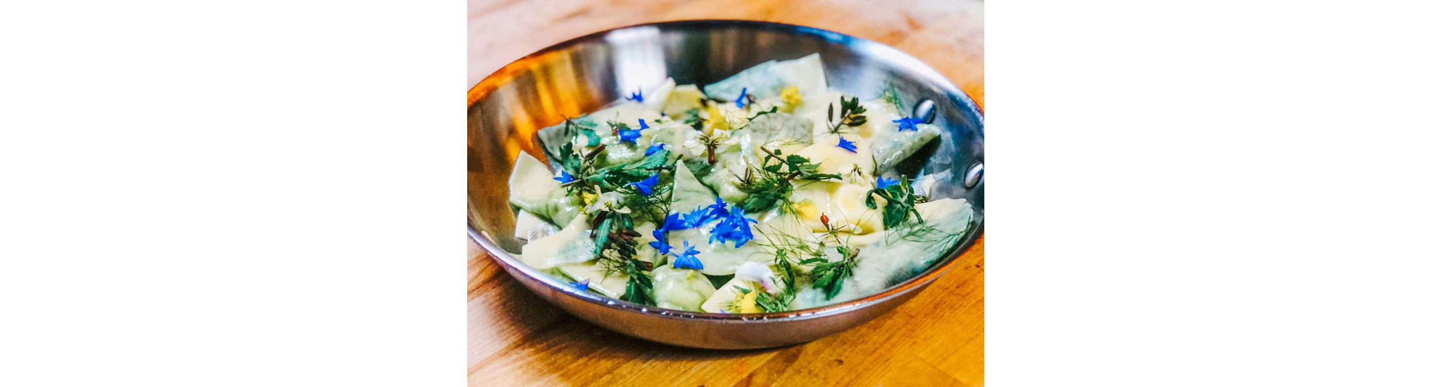 A dish topped with fresh, edible flowers.