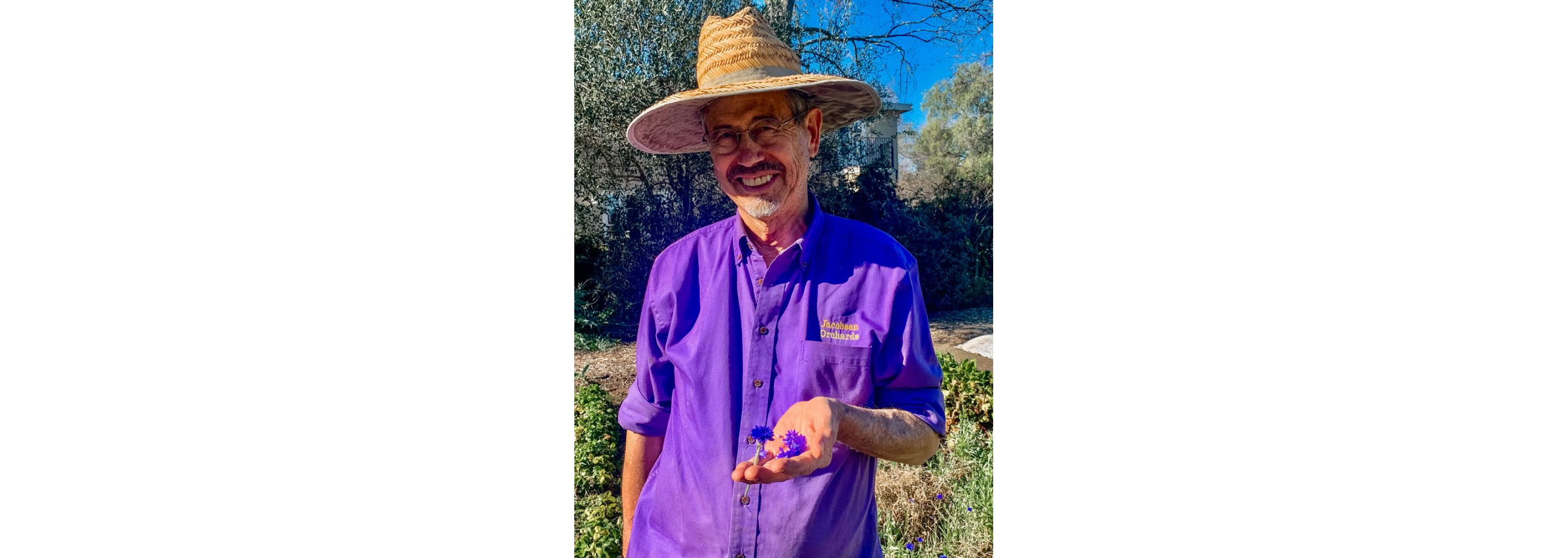 Peter Jacobsen holding delicate little flowers.
