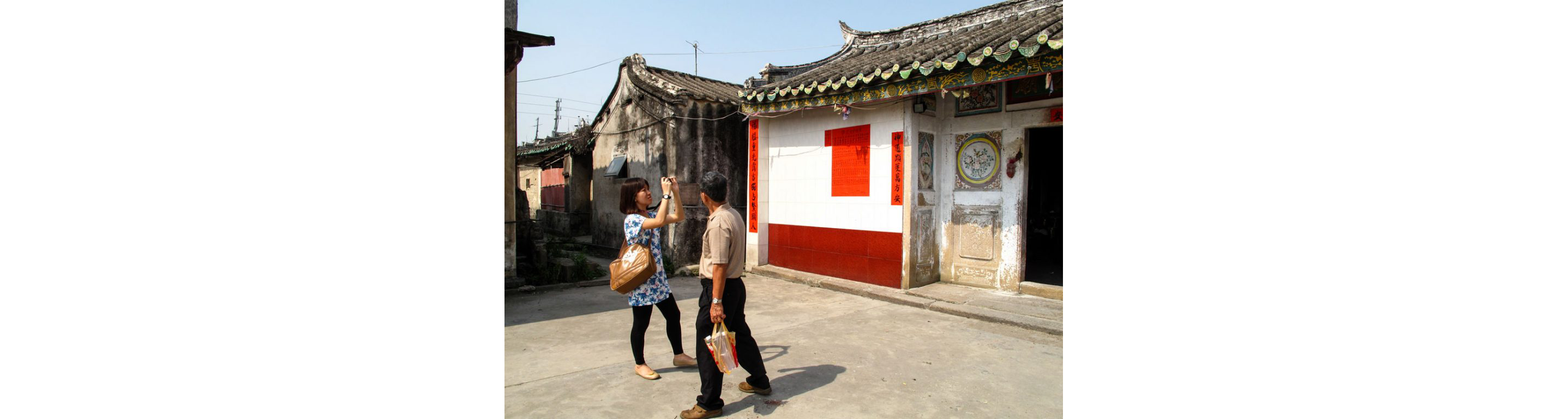 People taking pictures of the neighborhood.