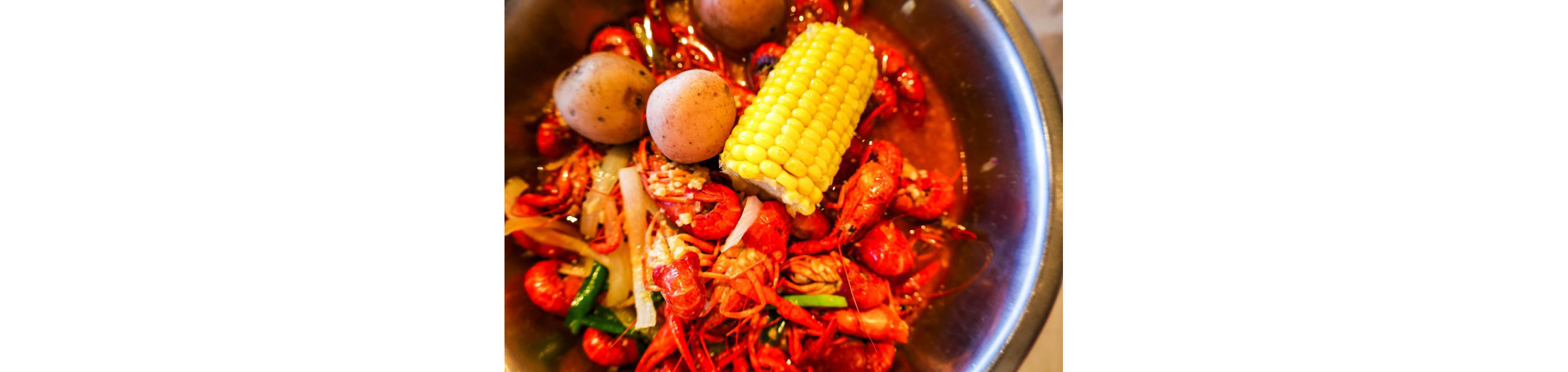 A crawfish boil with corn and potatoes.