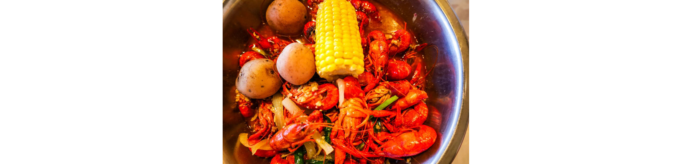 A crawfish boil with corn and potatoes.