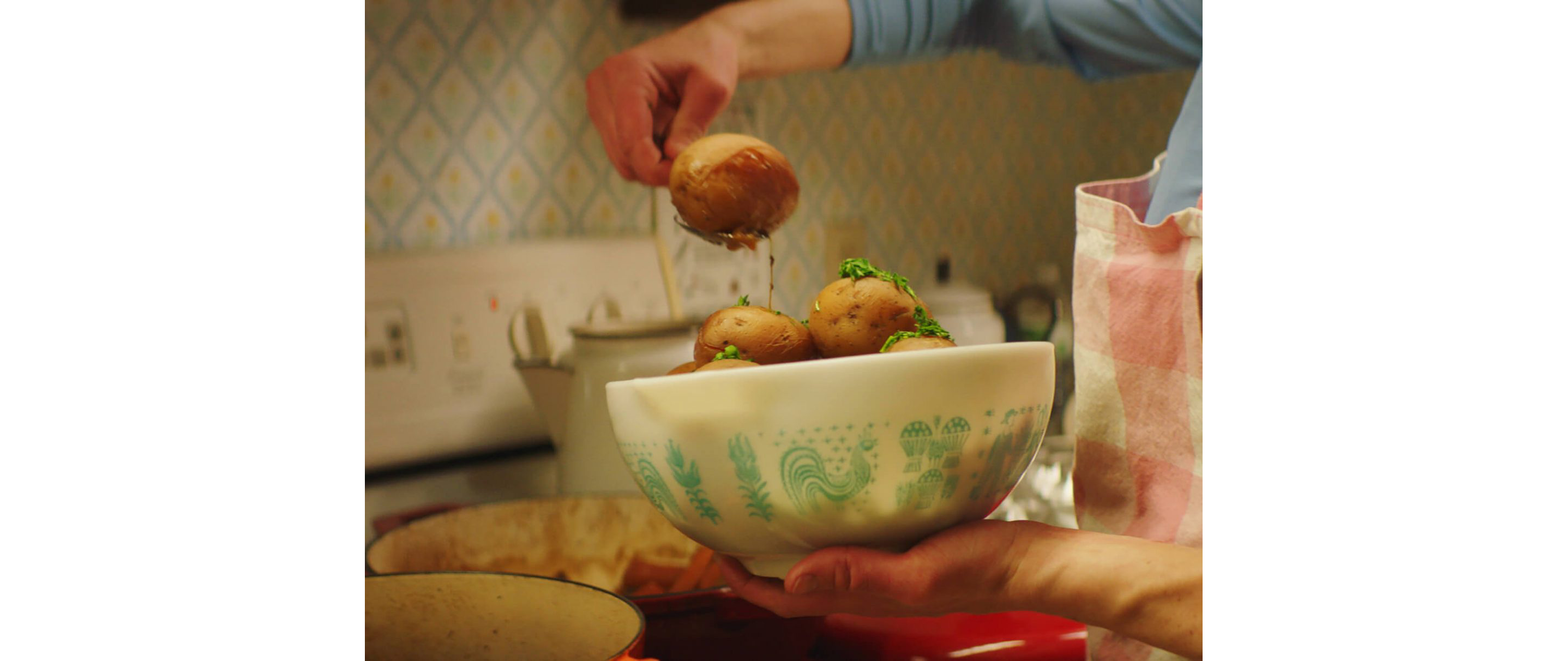 Karyn Tomlinson scooping potatoes out of a bowl.