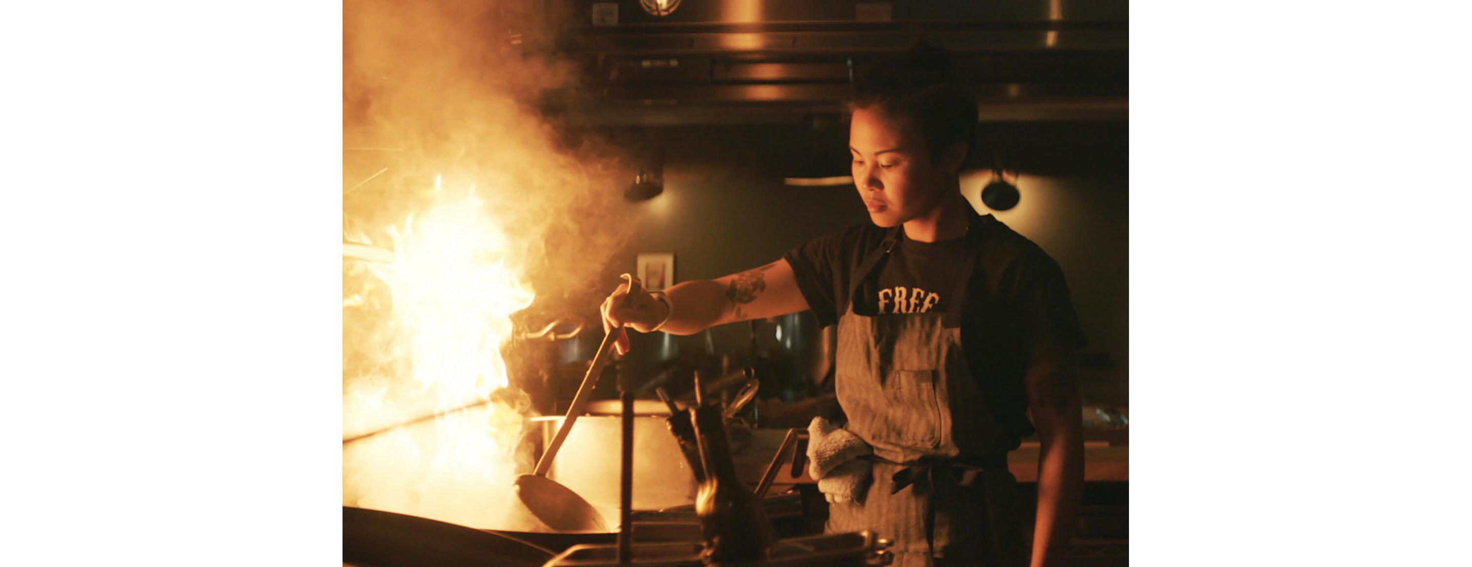 Marielle Fabie cooking over an open flame.