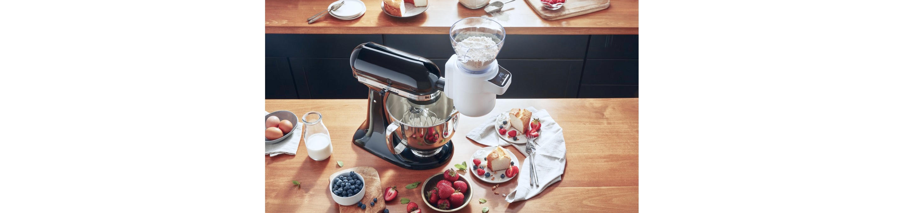 A KitchenAid® stand mixer mixing flour and other ingredients.