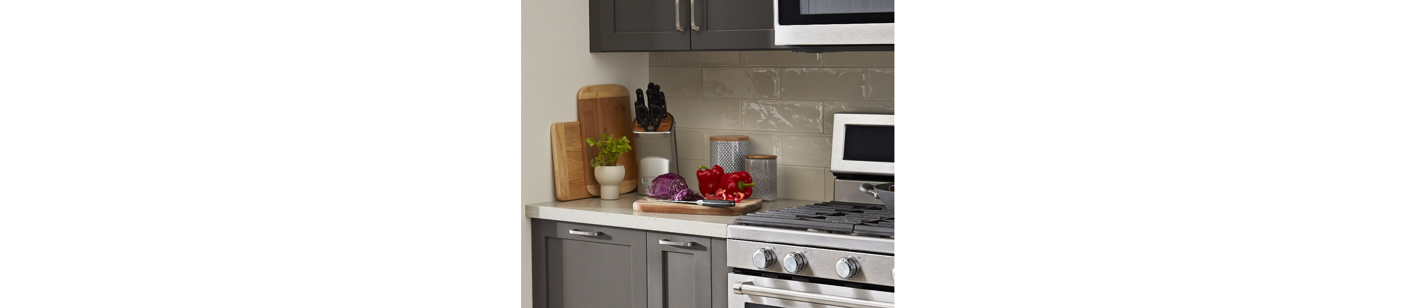 Countertop prep space with wooden cutting boards and a knife block