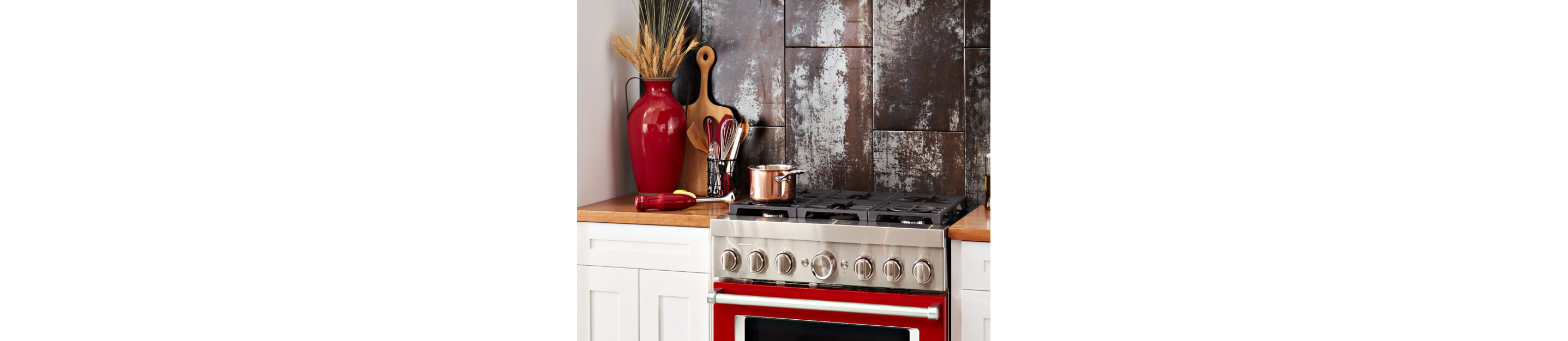 Cooking utensils beside a pot on the rangetop