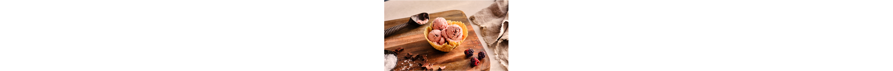 Blackberry chocolate chip ice cream in a waffle cone bowl.
