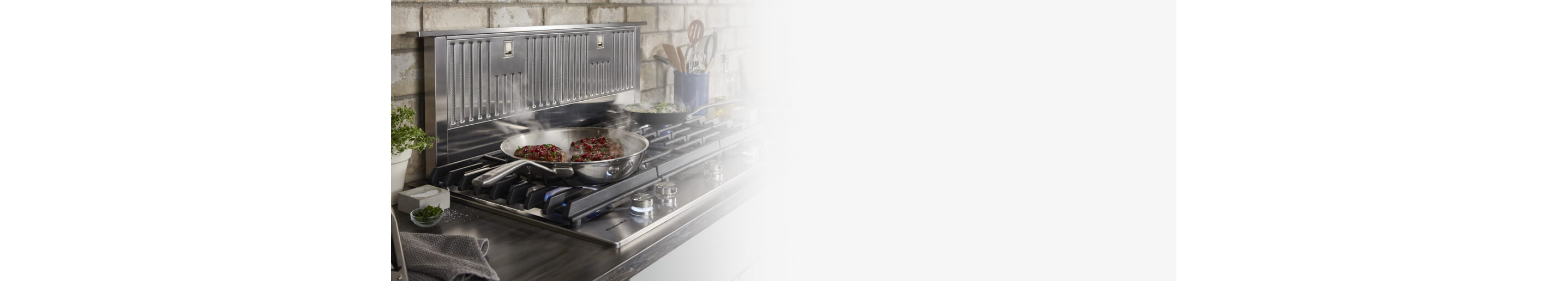 Retractable vent hood and a gas cooktop