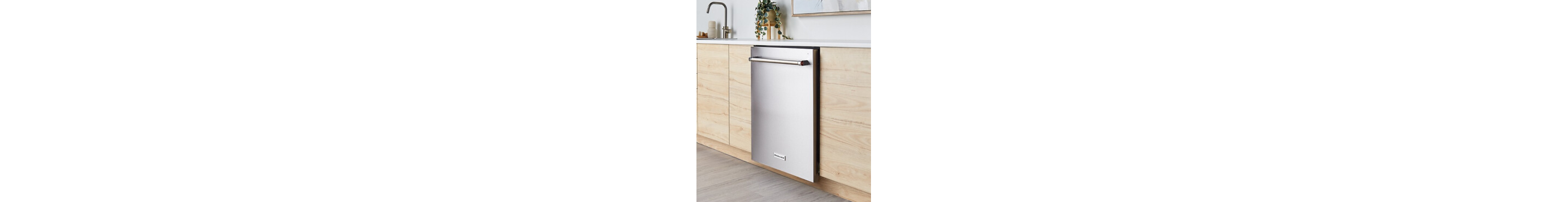 A built-in KitchenAid® dishwasher in a kitchen with light cabinets