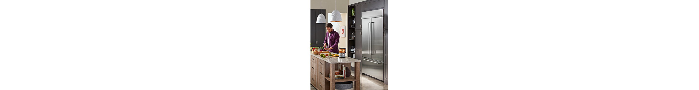 A person cooking in their kitchen with KitchenAid® appliances
