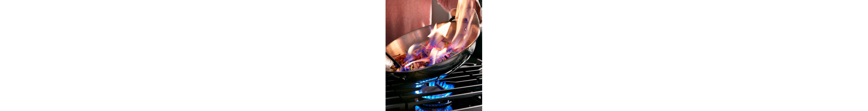 Person cooking in a wok on a gas range