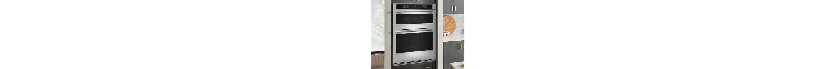 A KitchenAid® wall oven surrounded by gray cabinetry