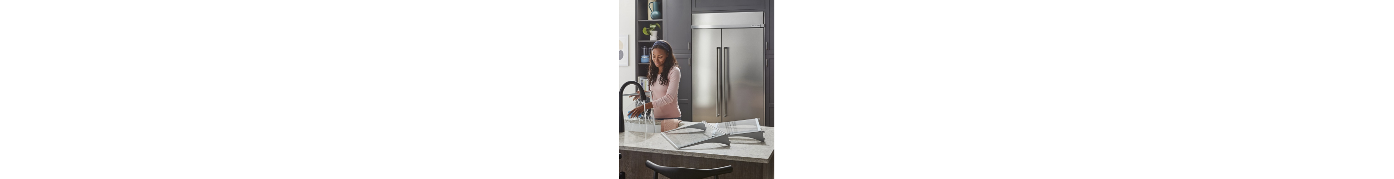 A person cleaning the shelves of their refrigerator
