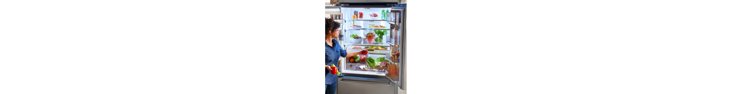 Person putting food in a refrigerator