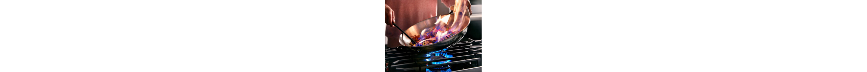 Person cooking on a gas cooktop