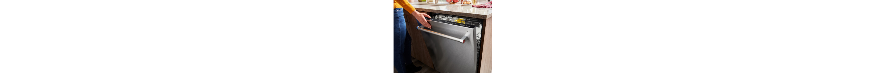 A hand closing a KitchenAid® top control dishwasher