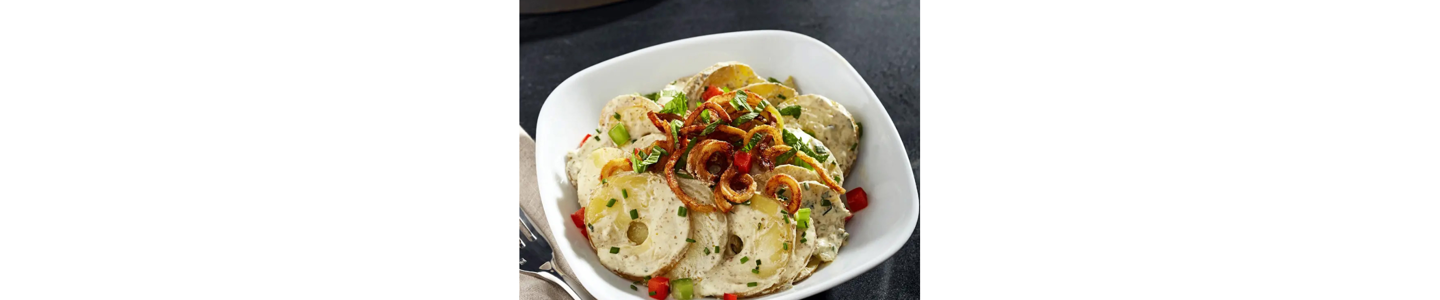 Pesto potato salad in white dish
