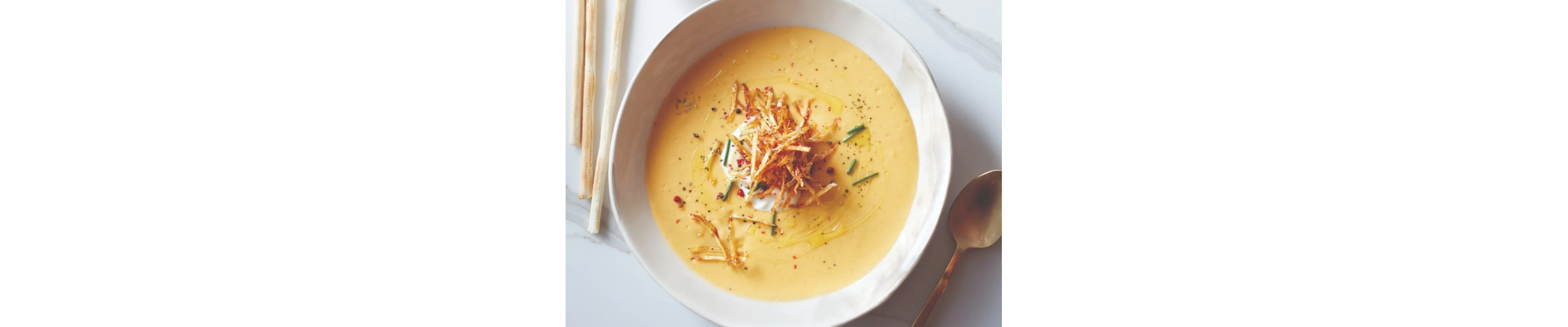 Potato cream soup in white bowl
