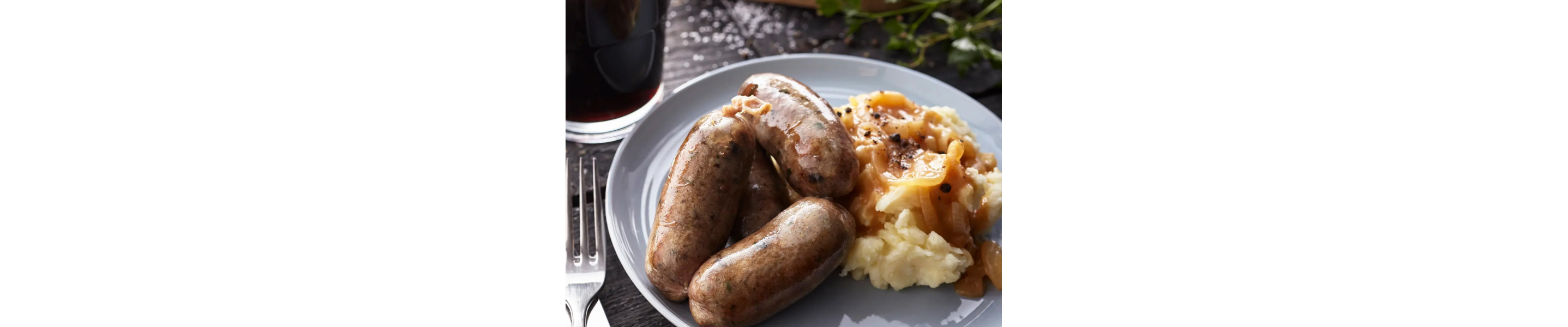 Sausage and mashed potatoes covered with gravy 