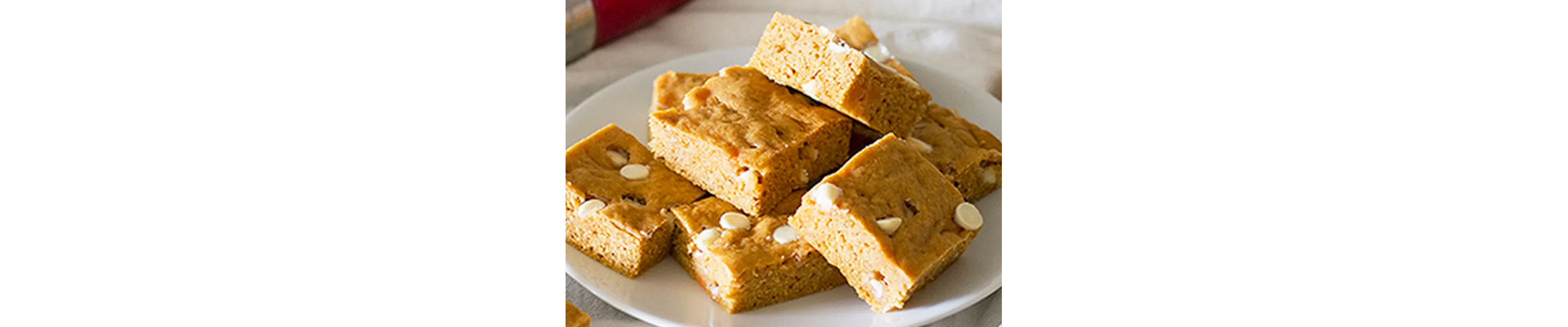 Sweet potato blondies with white chocolate chips on white plate