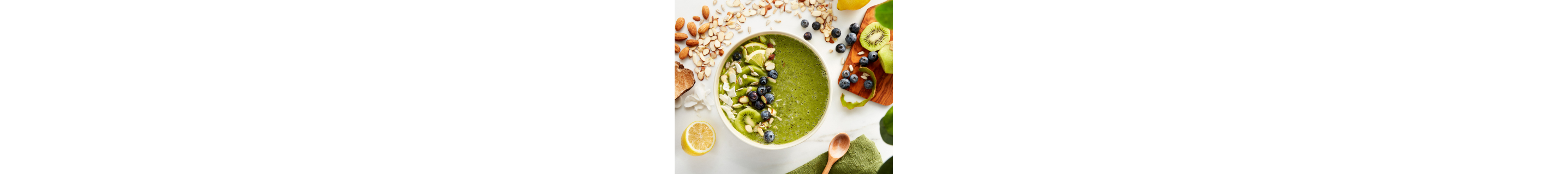 Green smoothie bowl topped with blueberries, kiwi and shaved almonds